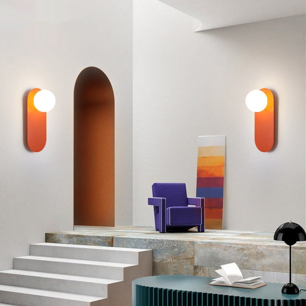 Modern interior with colorful wall lights and a purple chair.